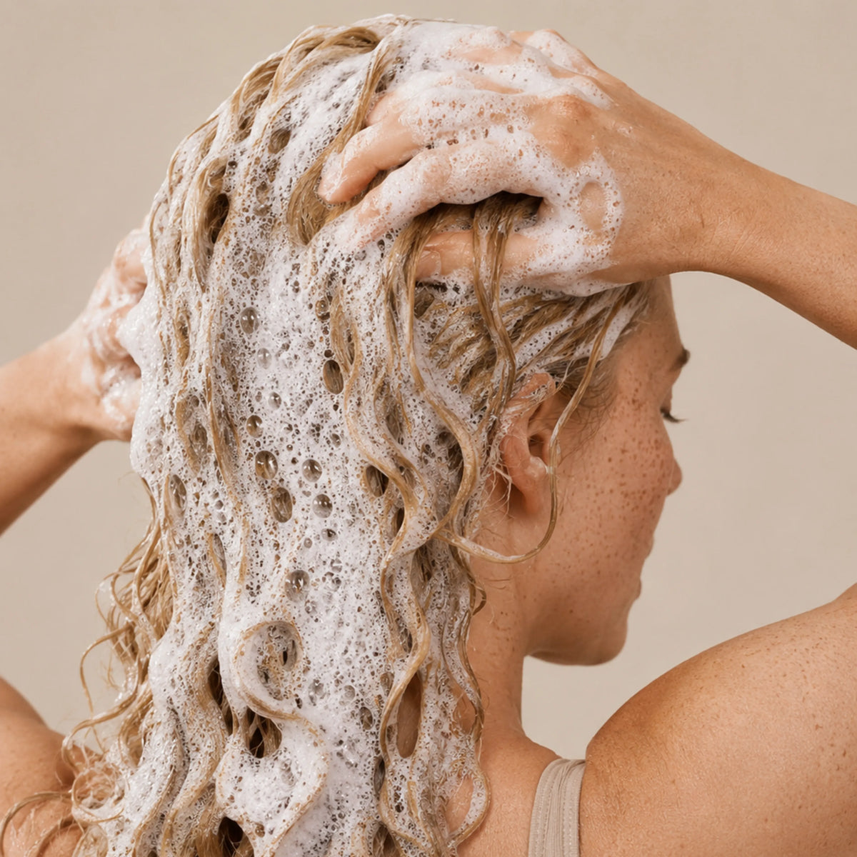 Woman washing curly hair